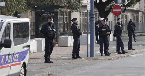 French authorities say high school where a teacher was fatally stabbed last week has been evacuated over a bomb alert
